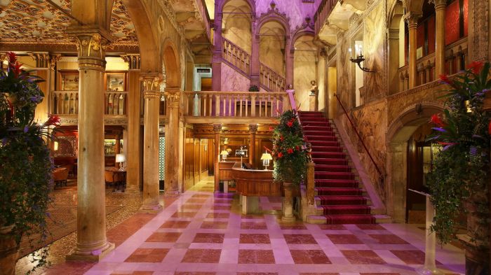 The golden staircase and pink marble columns of the four-storey atrium at Palazzo Dandolo
