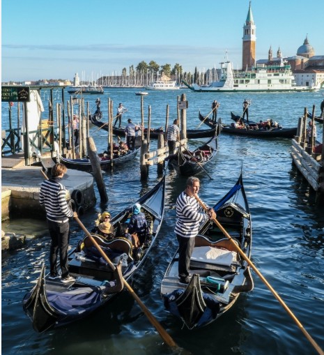 Gondolas moored on the water outside Hotel Danieli